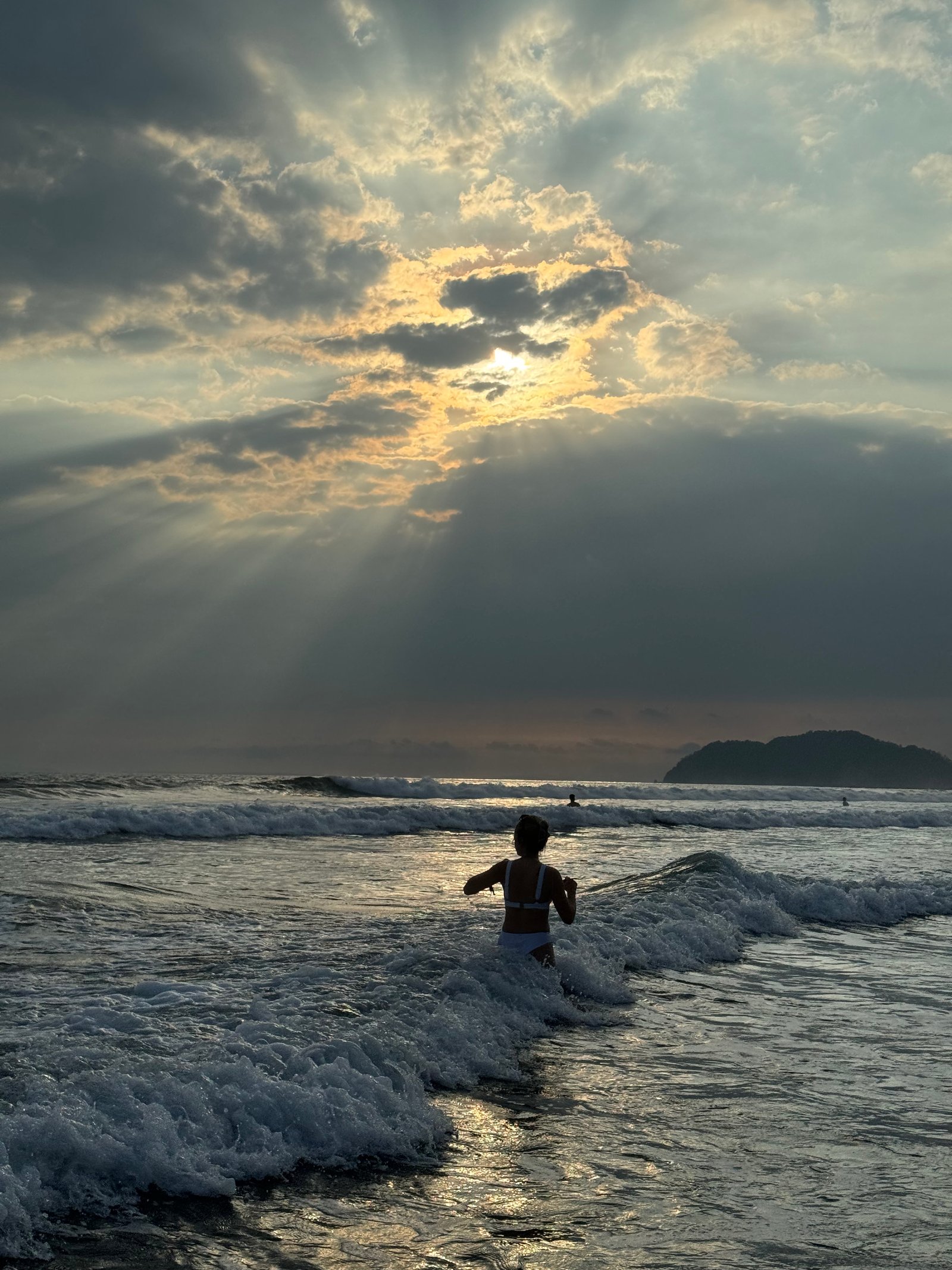 Travel Therapy — Pacific Ocean Costa Rica, woman entering the waves at sunset